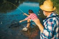 Portrait of cheerful senior man fishing. Grandfather and son fishermans. Young man and an old man fishing for spinnings Royalty Free Stock Photo