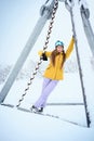 Portrait of cheerful skier girl in yellow jacket