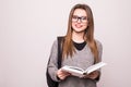 Portrait of a cheerful smiling african student girl wearing backpack and holding books isolated over white Royalty Free Stock Photo