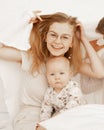 Portrait of cheerful smiling happy woman mother and baby covered white towel baby. Protection safety. Skin care, hygiene Royalty Free Stock Photo