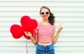 Portrait cheerful smiling woman with air balloons heart shape having fun over white Royalty Free Stock Photo