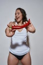 Cheerful woman holding hot pepper,  on white Royalty Free Stock Photo