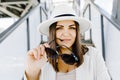 Portrait of a cheerful smiling woman wearing a stylish hat and glasses outdoors close up Royalty Free Stock Photo