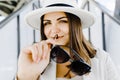 Portrait of a cheerful smiling woman wearing a stylish hat and glasses outdoors close up Royalty Free Stock Photo