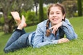 portrait of smiling young girl while lying in outdoors Royalty Free Stock Photo