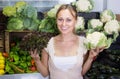 young woman buying cabbage at market. Royalty Free Stock Photo