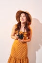 Portrait of cheerful smiling young woman taking photo with inspiration and wearing summer dress. Girl holding retro camera. Model Royalty Free Stock Photo