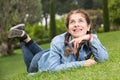 portrait of young female while lying in spring green garden Royalty Free Stock Photo