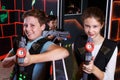 Girl and boy playing laser tag Royalty Free Stock Photo