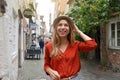 Portrait of cheerful traveler woman walking in Schnoor neighborhood, Bremen, Germany