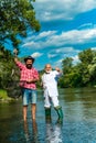 Portrait of cheerful two bearded men fishing. Hobby for soul. Retirement fishery. Friends fishing. Successful fly Royalty Free Stock Photo