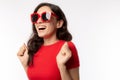 Portrait cheerful woman. Attractive beautiful young woman wears sunglasses, red t shirt with smiley face. Gorgeous girl get happin