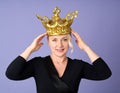 Portrait of cheerful woman with golden crown