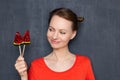 Portrait of cheerful woman holding two lollipops in hand