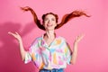 Portrait of cheerful woman wear print shirt hands fluttering foxy hair look up at logo empty space isolated on pink Royalty Free Stock Photo