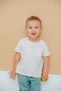 Portrait of a cheerful 5 year old boy over brown background Royalty Free Stock Photo