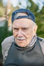 Portrait of a cheerful 88-year-old man in a baseball cap. Happy active old age Royalty Free Stock Photo