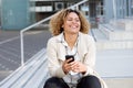 Cheerful young african american woman with mobile phone outside Royalty Free Stock Photo