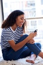 Cheerful young african american woman smiling with cellphone Royalty Free Stock Photo