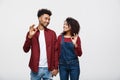 Portrait of a cheerful young african couple standing together and showing ok gesture isolated over white background Royalty Free Stock Photo