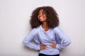 Cheerful young african woman laughing on white background