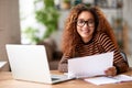 Happy young african american woman smiling at camera while working remotely studying online from home Royalty Free Stock Photo