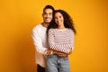 Portrait of cheerful young arab couple embracing and smiling at camera Royalty Free Stock Photo