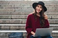 Portrait of a cheerful young asian woman in hat Royalty Free Stock Photo