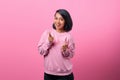 Portrait of cheerful young asian woman pointing fingers to camera with smiling face Royalty Free Stock Photo