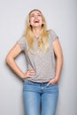 Cheerful young blond woman laughing and looking up Royalty Free Stock Photo