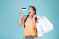 Portrait of cheerful young brunette woman holding credit card and shopping bags Royalty Free Stock Photo