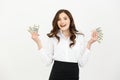 Portrait of a cheerful young business woman holding money banknotes and celebrating isolated over white background. Royalty Free Stock Photo