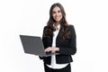 Portrait of a cheerful young casual girl standing isolated over gray background, using laptop computer. Business woman Royalty Free Stock Photo