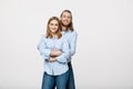 Portrait of cheerful young couple standing and hugging each other on isolated white background Royalty Free Stock Photo