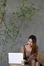 Cheerful young female using laptop computer at cafe. Royalty Free Stock Photo