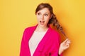 Portrait of a cheerful young girl in bright casual clothes smiling at the camera with beautiful smile. Colorful background Royalty Free Stock Photo