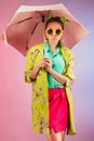 Portrait of a cheerful young girl in bright casual clothes smiling at the camera with beautiful smile. Colorful background Royalty Free Stock Photo