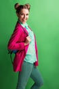 Portrait of a cheerful young girl in bright casual clothes smiling at the camera with beautiful smile. Colorful background Royalty Free Stock Photo