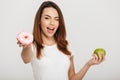 Portrait of a cheerful young girl giving a donut Royalty Free Stock Photo