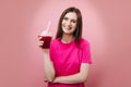 Cheerful girl in pink t-shirt holding cold fresh cocktail Royalty Free Stock Photo