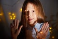 Portrait of cheerful young girl resting festal day december winter in room decorated for Christmas. Child in Royalty Free Stock Photo