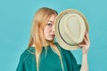 Portrait of a cheerful young girl in a summer hat, dressed in summer clothes posing on blue background Royalty Free Stock Photo