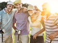 Portrait of cheerful young golfers on golf course Royalty Free Stock Photo