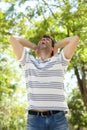 Young man laughing outdoors with his hands behind head Royalty Free Stock Photo