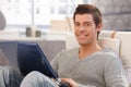 Portrait of cheerful young man using computer Royalty Free Stock Photo