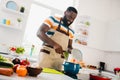 Portrait of cheerful young person enjoy preparing fresh vegetable soup free time kitchen indoors Royalty Free Stock Photo