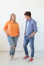 Portrait of a cheerful young positive couple in full growth dressed in casual clothes posing on a white background Royalty Free Stock Photo