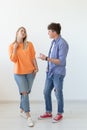 Portrait of a cheerful young positive couple in full growth dressed in casual clothes posing on a white background Royalty Free Stock Photo