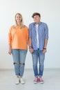 Portrait of a cheerful young positive couple in full growth dressed in casual clothes posing on a white background Royalty Free Stock Photo