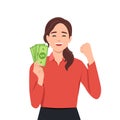 Portrait of a cheerful young woman holding money banknotes and celebrating isolated over yellow background Royalty Free Stock Photo